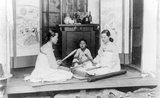 In Korea the drumming of traditional ironing sticks was traditionally considered a joyful sound, a symbol of a secure home life. Two women knelt on the floor, facing each other across a smoothing stone or <i>tatumi-tol</i>, a <i>pangmangi</i> club in each hand, beating out a rhythm on the cloth.<br/><br/>A Korean <i>tatumi-tol</i> granite or marble block was a valued family possession, perhaps with carved decoration, especially on the underside, so the design was visible when it was stored upside down to protect the smooth top. Ironing with pangmangi clubs requires skillful co-ordination and partnership.